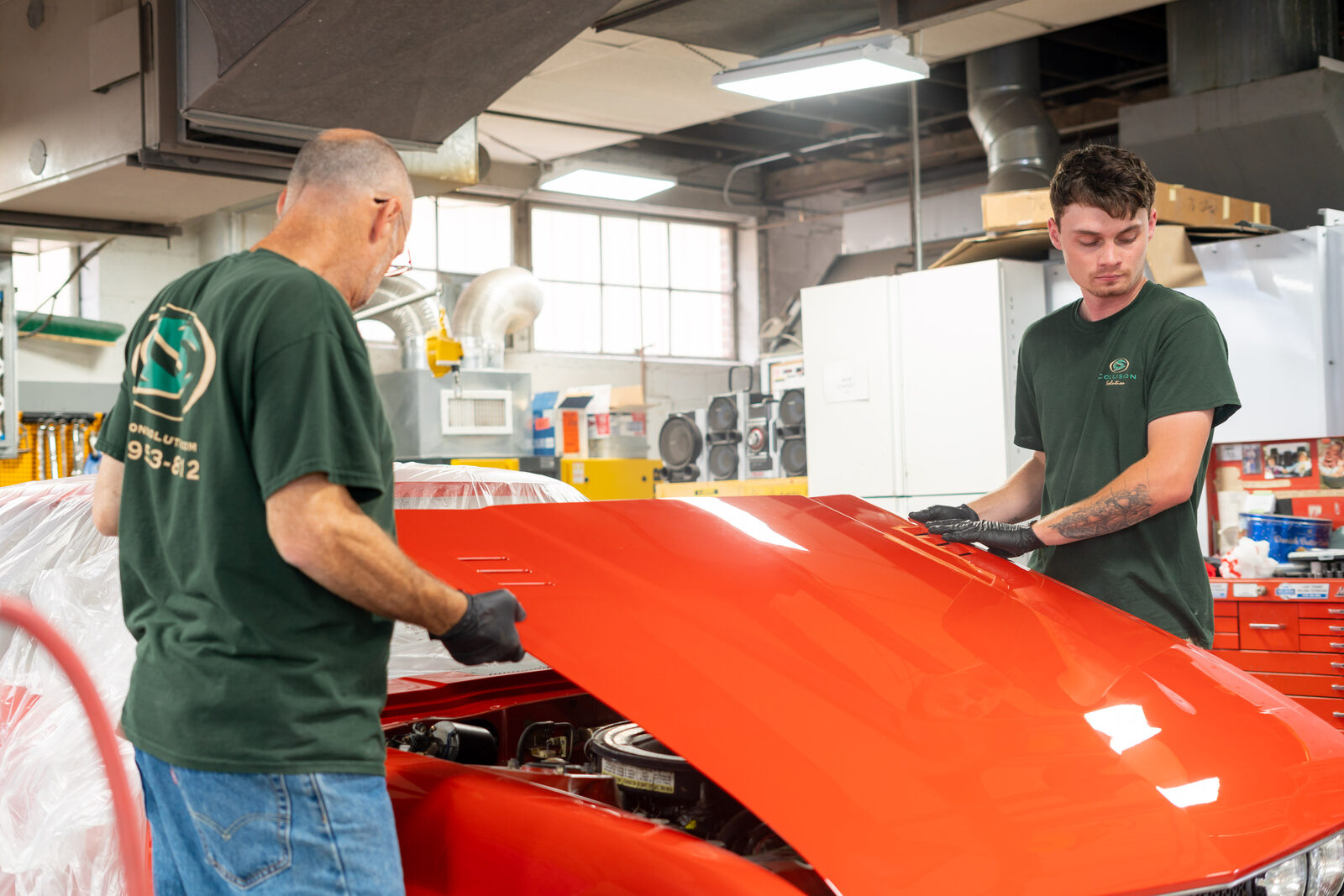 Collision Solution technicians repairing a vehicle in the shop