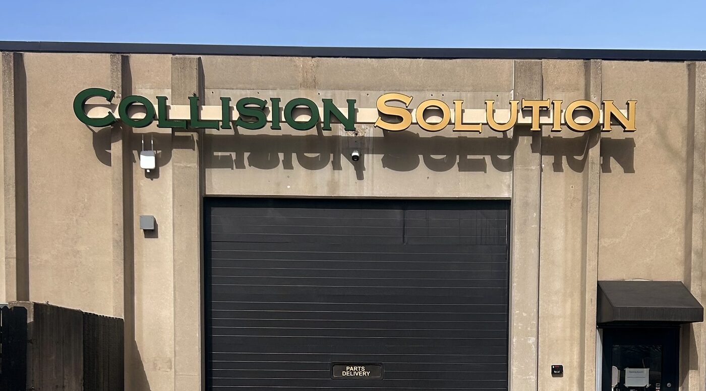 The Collision Solution sign above the service bay at the 16th Street shop in Zion