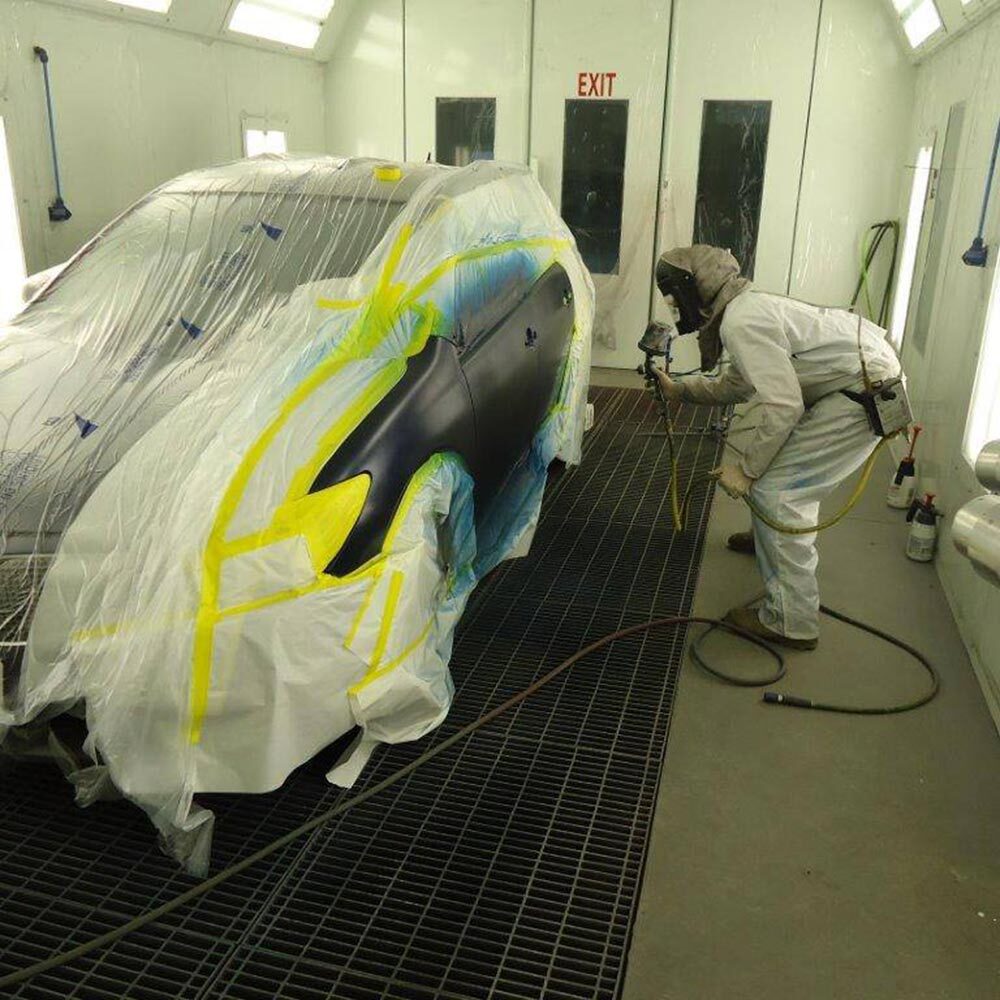 Refinishing a vehicle in the downdraft paint booth